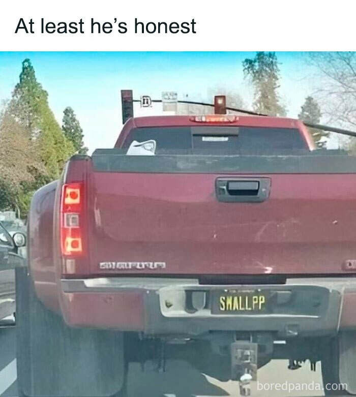 Red truck with a humorous license plate, popular among car-related memes for drivers.