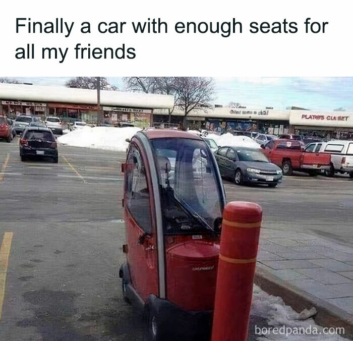 Small red vehicle in parking lot with humorous caption, representing car memes for drivers.