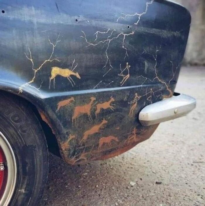 Car with rust imitating cave paintings, resembling a humorous car-related meme for drivers.