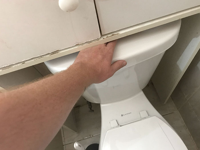 My Landlord Decided To Put A Cabinet Over The Toilet Flushing Button, So I Have To Jam My Hand Underneath The Wood To Flush Every Time