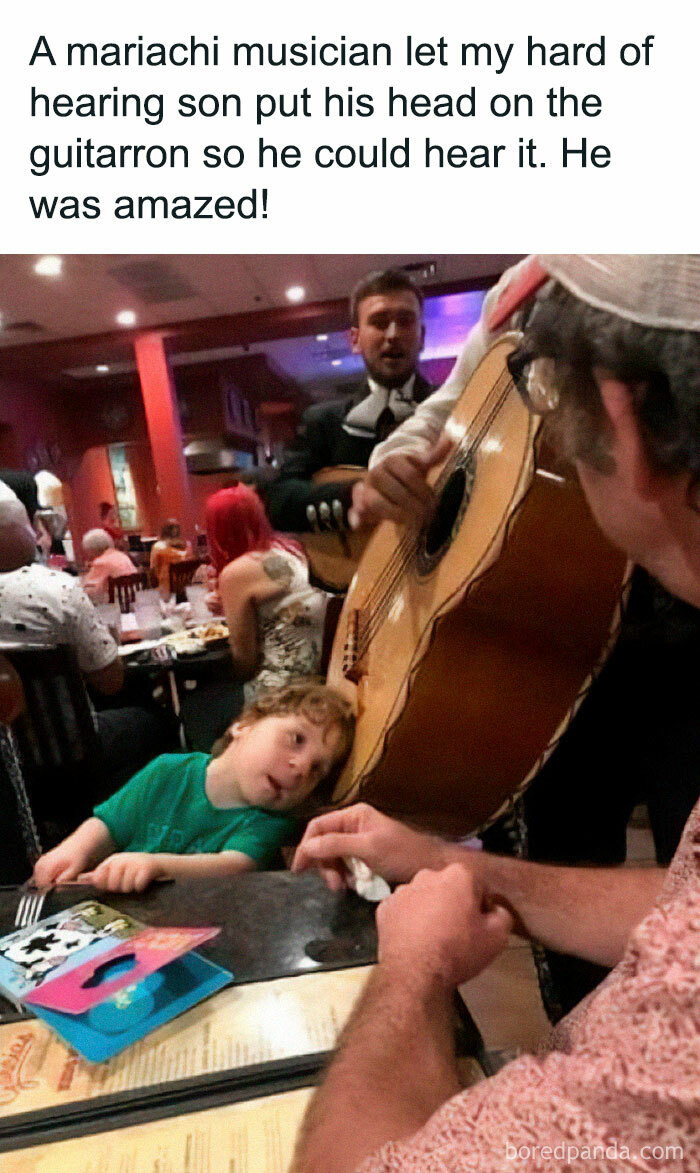 A mariachi musician helps a hard of hearing child hear the guitar, a wholesome moment showing the world isn’t all bad.