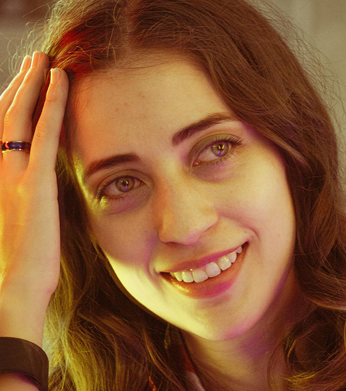 Close-up of a smiling woman highlighting minor attractive features on women that often go unnoticed.