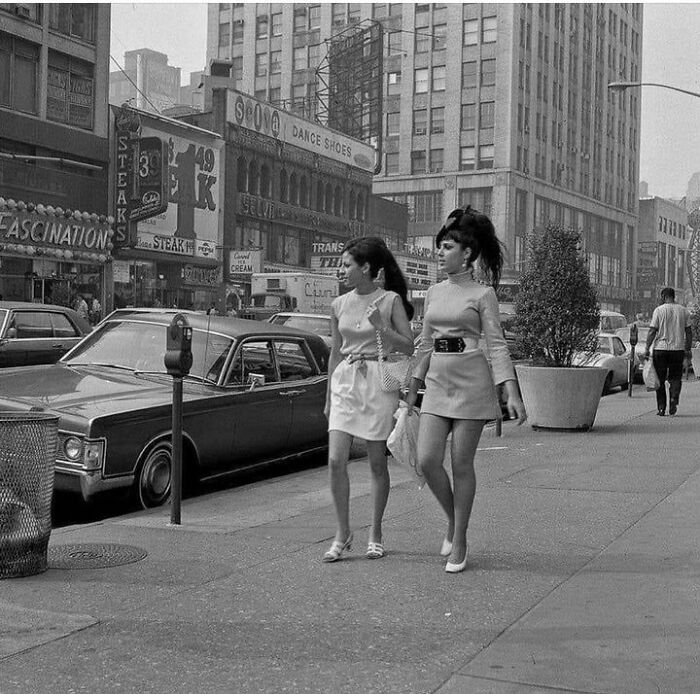 Two Young Women Walking Along Broadway Between 48th And 49th Streets. New York (1969) What Stands Out?