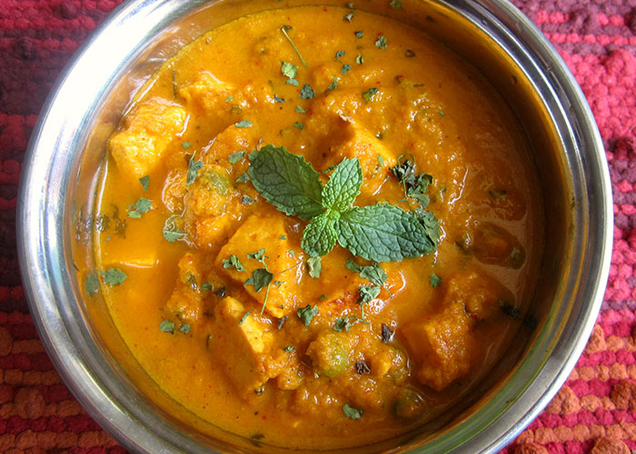 Close-up of a spiced food dish garnished with fresh herbs, illustrating food thieves at work lesson concept