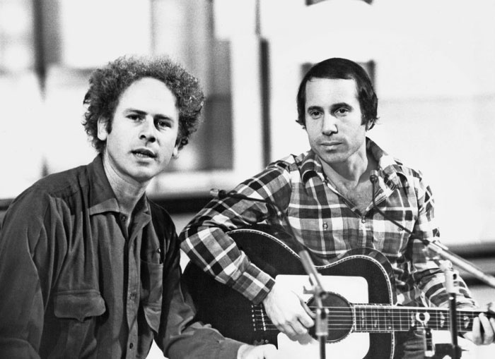 Two iconic musicians performing together, one with a guitar.