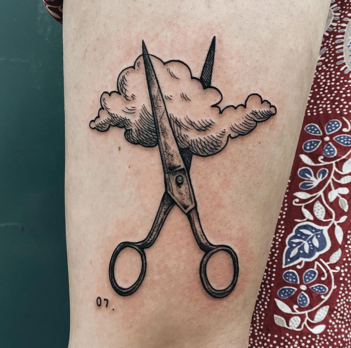 Creative tattoo ideas for men featuring a pair of scissors intersecting with a fluffy cloud, combining realism and surrealism for a whimsical and thought-provoking design.