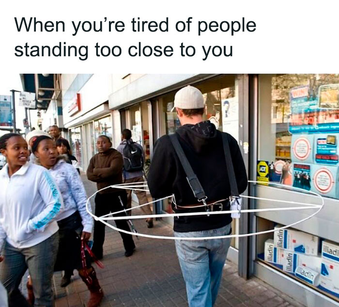 Man wearing a personal space device while walking outside, depicting funny and relatable memes about life as an introvert.