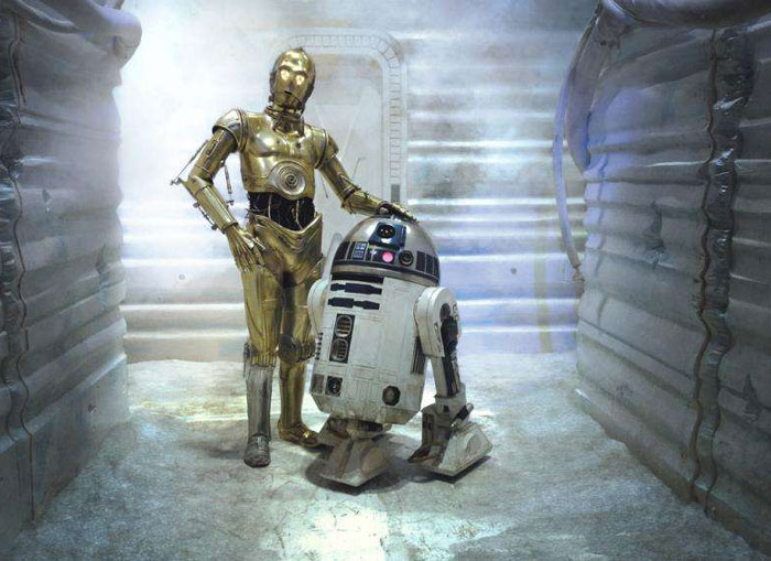 Iconic duos: two robots stand together in a futuristic setting.