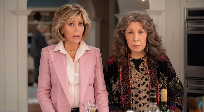 Two women standing together in a kitchen, capturing the essence of iconic duos.