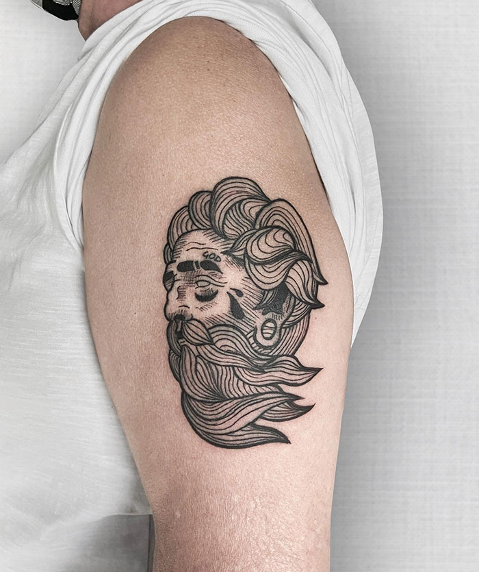Classical tattoo ideas for men featuring a linework portrait of a god-like figure with flowing hair and beard, detailed with bold outlines and intricate shading for a timeless and powerful design.