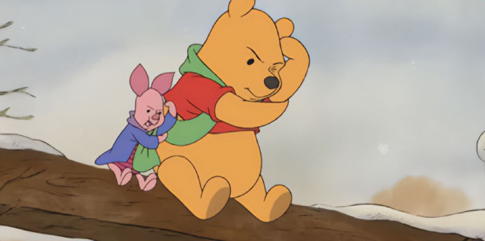 Animated iconic duo walking on a snowy log, wearing colorful jackets in a winter scene.