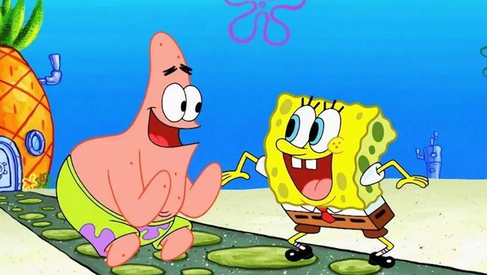 Animated iconic duo laughing on a vibrant undersea path.