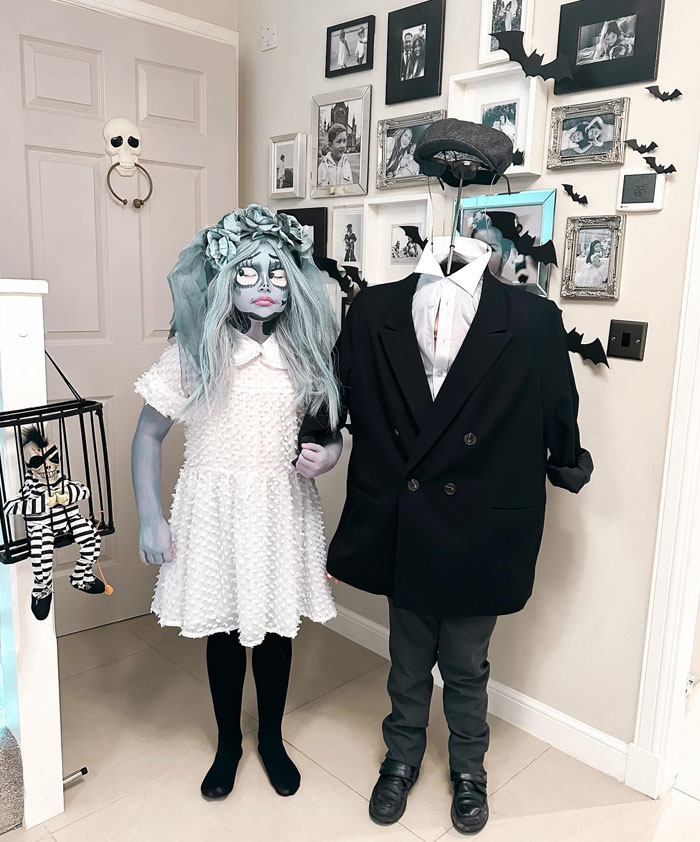 Two kids in creative Halloween costumes with face paint and a headpiece, showcasing unique kids Halloween costume ideas.