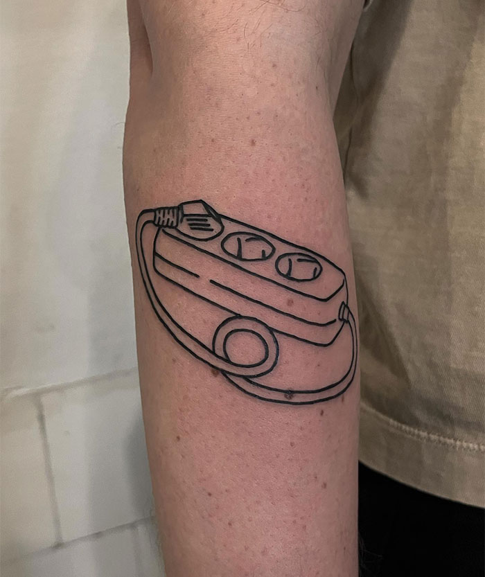  Minimalistic tattoo ideas for men featuring a clean linework design of a power strip with a coiled cord, creating a quirky and modern concept with a simple black ink style.