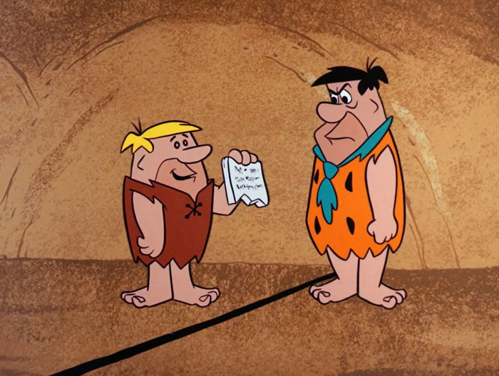 Animated iconic duos in a prehistoric setting, one holding a paper, both wearing traditional garments.