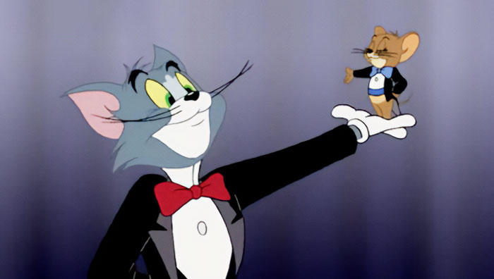 Cartoon cat and mouse in tuxedos, illustrating iconic duos.