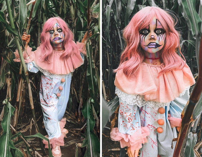 Child in creative kids Halloween costume with pink wig and clown makeup standing in a cornfield for Halloween costume ideas.