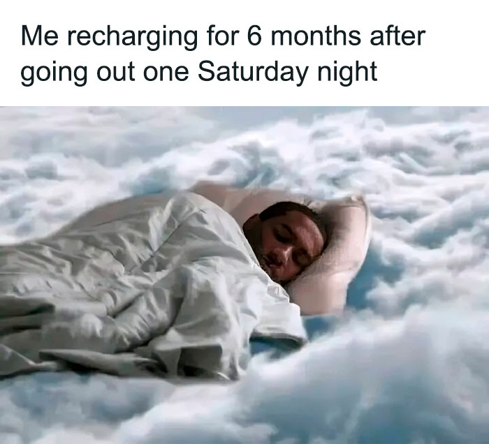 Person sleeping peacefully wrapped in a blanket on a cloud bed, illustrating funny and relatable introvert memes about recharging energy.