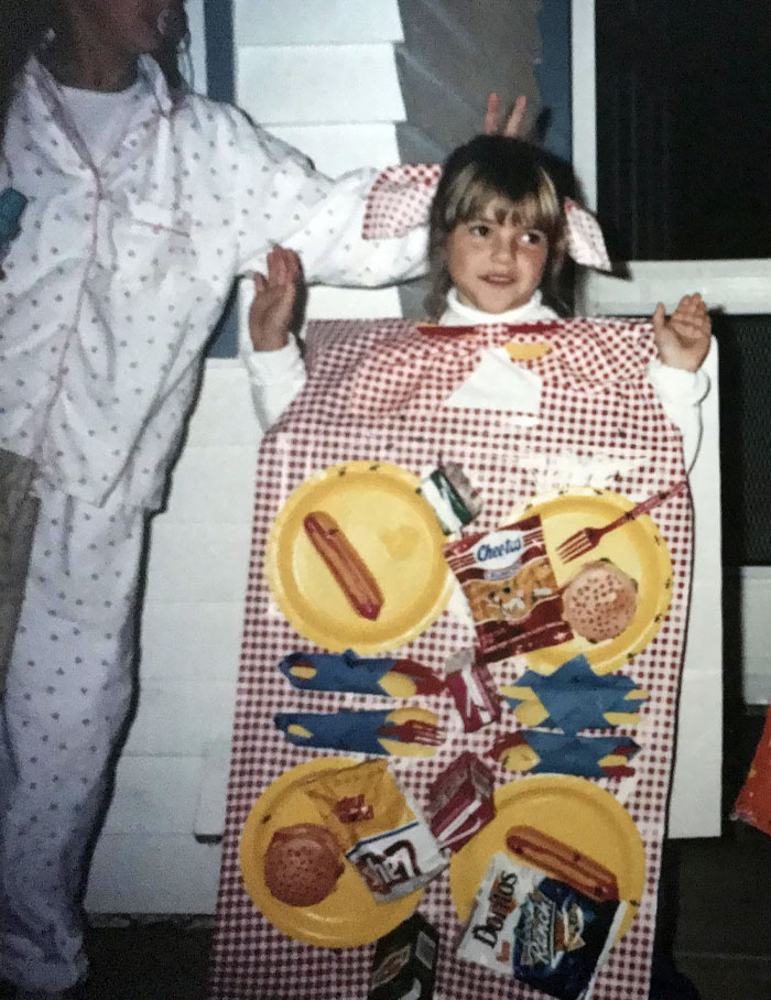 Child dressed in a creative picnic table costume with plates and snack bags, showcasing kids Halloween costume ideas.