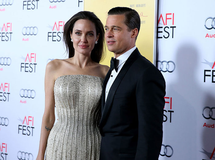 A couple posing on a red carpet at an AFI FEST event, showcasing iconic duos.