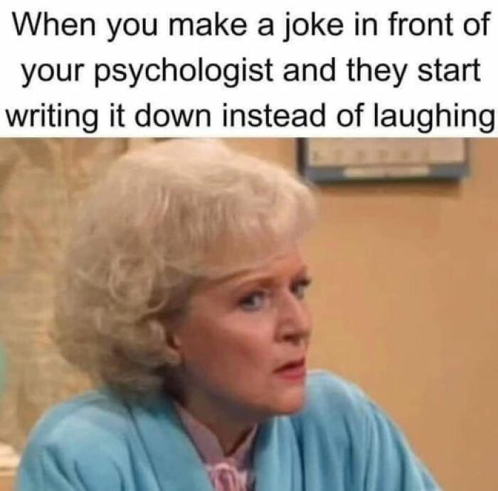 A perplexed woman in a blue cardigan reacting to an unexpected psychologist's response.