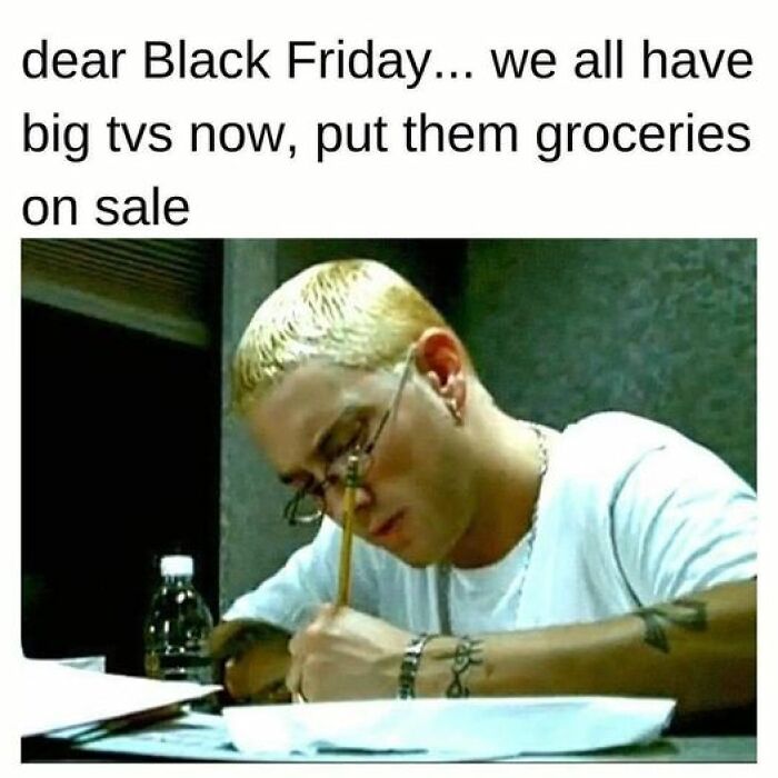 A man with glasses writes a humorous Black Friday twist note.