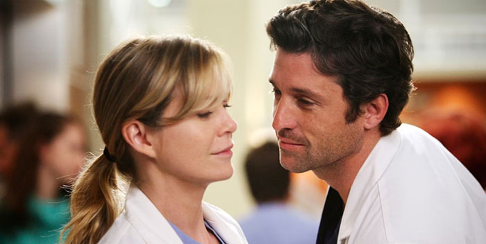 A man and woman in medical attire sharing an intimate moment, representing iconic duos.