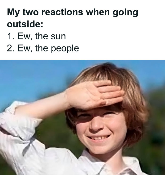 Boy shielding eyes from the sun with hand, expressing funny and relatable introvert life reactions to going outside.
