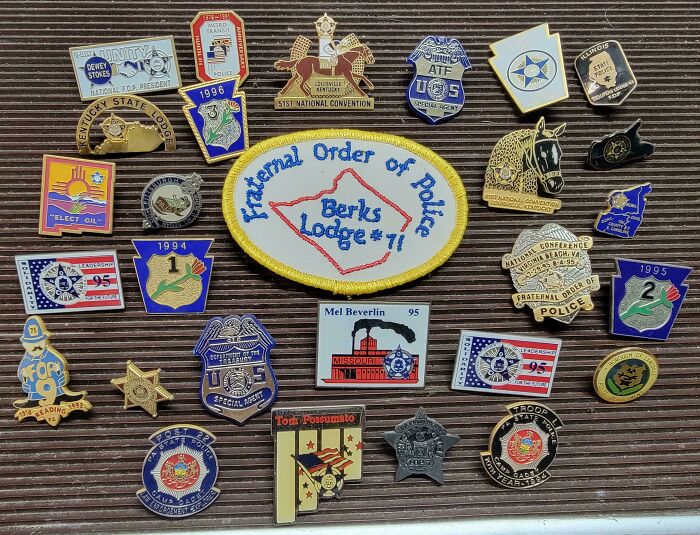 Collection of Fraternal Order of Police pins and badges found while dumpster diving.