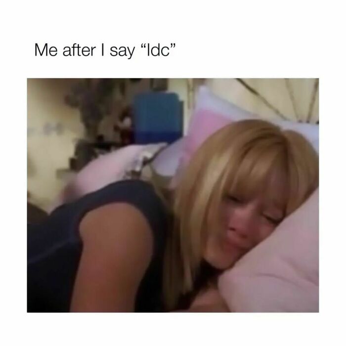 Woman lying on a bed with a sad expression, illustrating a humorous moment from hilarious memes to save your day.