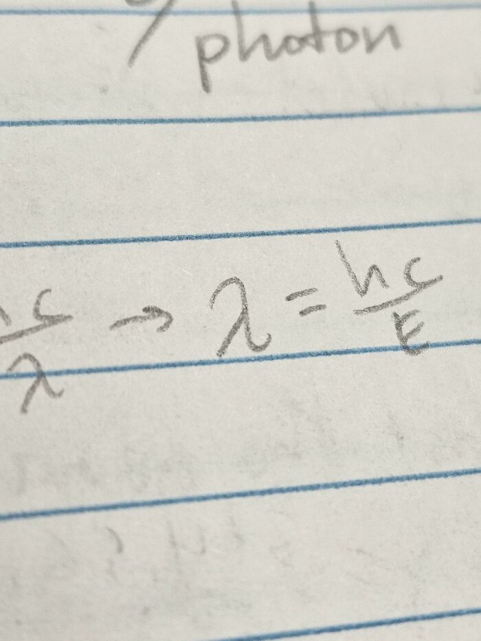 Handwritten physics equation on lined paper, showcasing something mildly interesting.