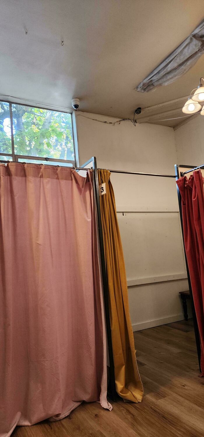 Creepy images of dressing rooms with cameras, showing pink, gold, and red curtains. Potential risk to kids.