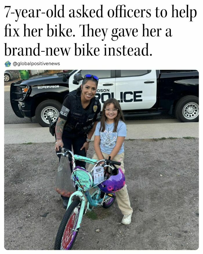 Police officer surprises a smiling young girl with a new bike, showcasing faith in humanity restored.