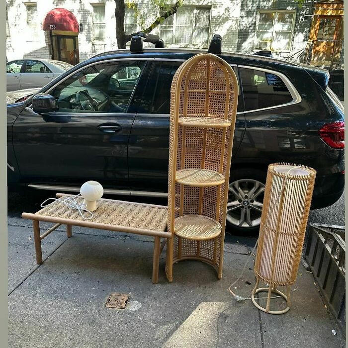 Rattan furniture and lamp set on the curb, showcasing Stooping NYC treasures for others to discover.