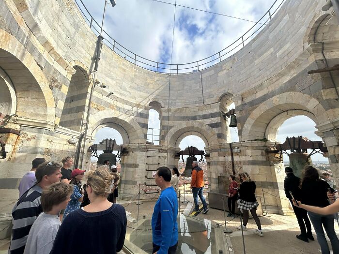 Visitors inside the Leaning Tower of Pisa, exploring the historic structure from a new perspective.