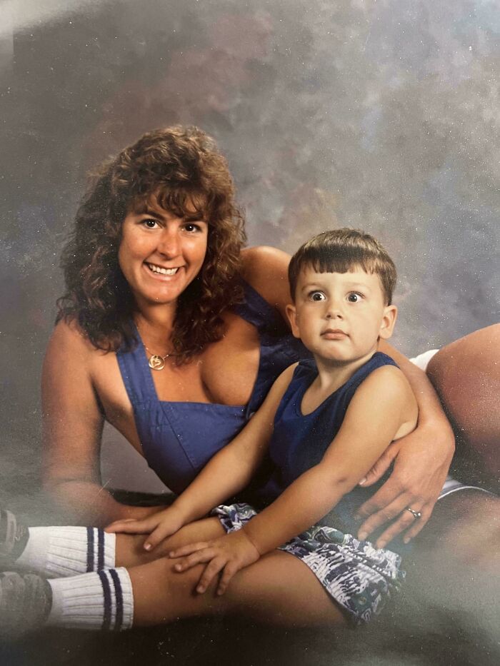Woman and child in matching blue outfits, posing for a retro studio portrait.