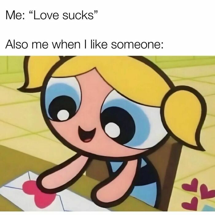 Cartoon character smiling while holding a heart-decorated letter, relatable memes expressing love feelings humorously.
