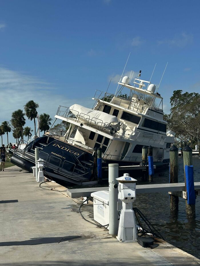 Two large boats tilted and partially submerged at a dock, illustrating unfortunate incidents that looked expensive.