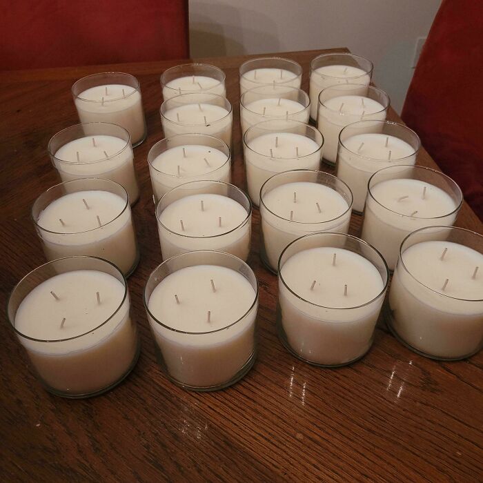 Candles arranged on a wooden table, found while dumpster diving, showcasing a frugal treasure.