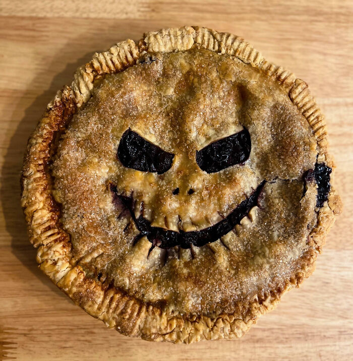 Halloween snack pie with a spooky carved face, showcasing creative and festive Halloween snacks for the season.