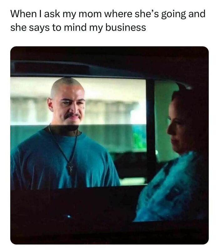 Man with a smirk looking at woman in car window, humorous relatable meme about minding business.