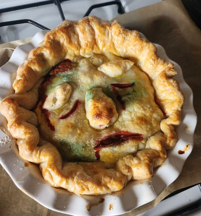 Halloween snack pie with a creative face design, featuring golden crust and colorful filling, perfectly baked and ready to serve.