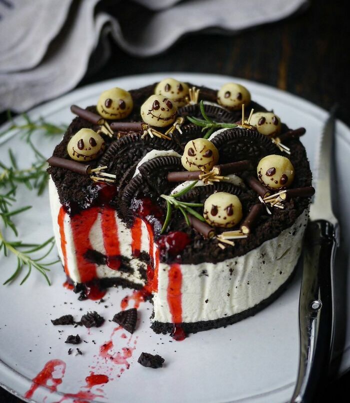 Halloween snacks featuring a creamy cake with cookie crumbles, chocolate decorations, and spooky edible faces on top.