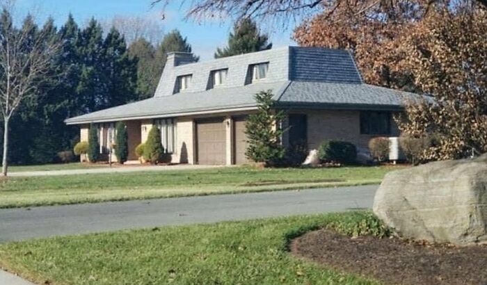 Unusual house design with a roof resembling an old computer, exemplifying cringeworthy design fails in architecture.