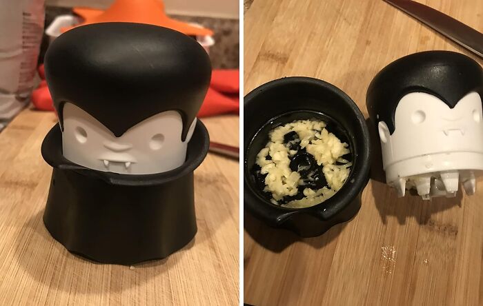 Cute vampire-shaped garlic press on wooden cutting board, one closed and one open with chopped garlic inside, Amazon finds.