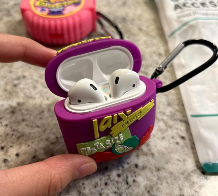 AirPods in a colorful protective case with a carabiner clip, one of the unexpectedly brilliant Amazon finds.