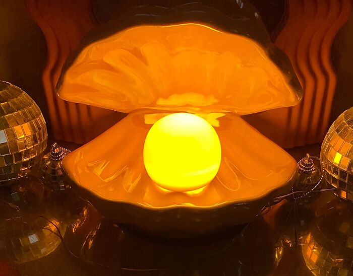 Glowing pearl light inside clam shell lamp, one of the brilliant Amazon finds for unique home decor ambiance.