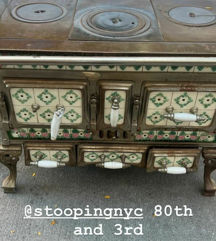 Vintage stove with floral ceramic handles left on NYC curb for stooping.