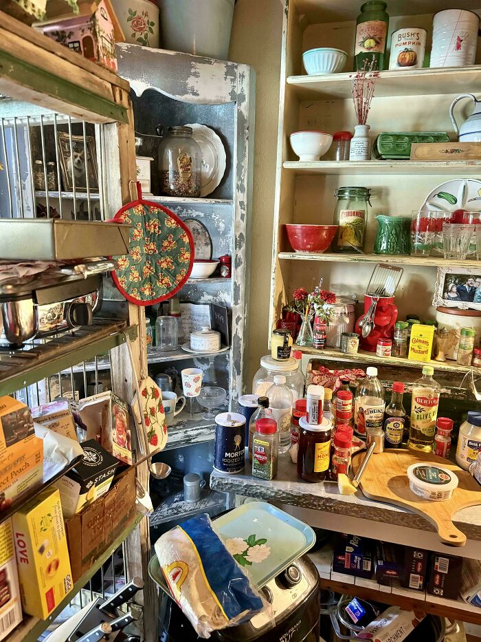A cluttered kitchen shelf with various items seamlessly merged into the background, showcasing food cans and glass jars.