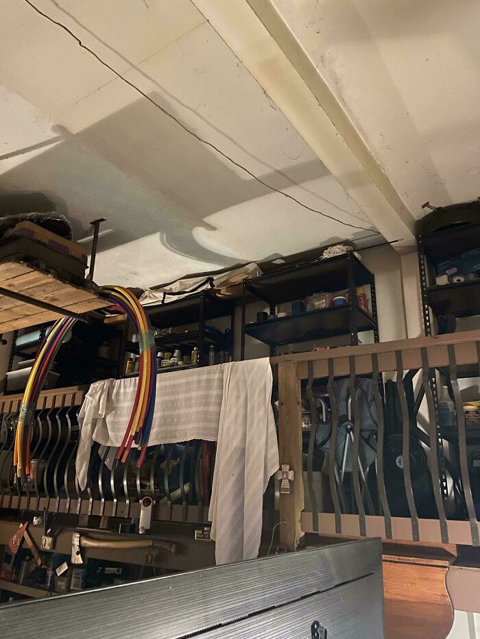 Objects seamlessly merged into the background; colorful cables hang over storage shelves, creating a camouflaged effect.